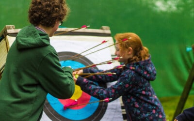 children pulling arrows out of target