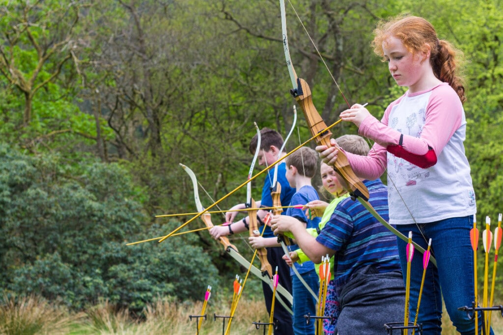 children lining up to do archery