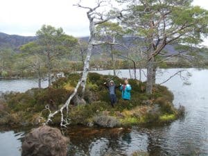 The loch on an island in a loch on an island in a loch on an island! Their feet are almost in it.