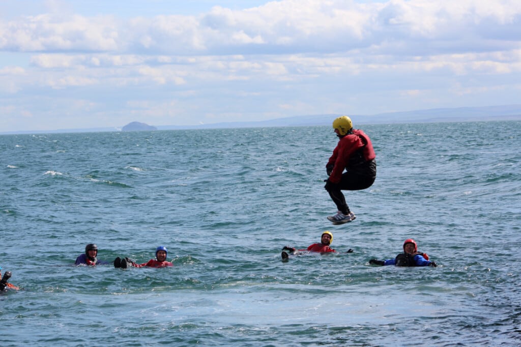 coasteering - jumping off cliff into the sea