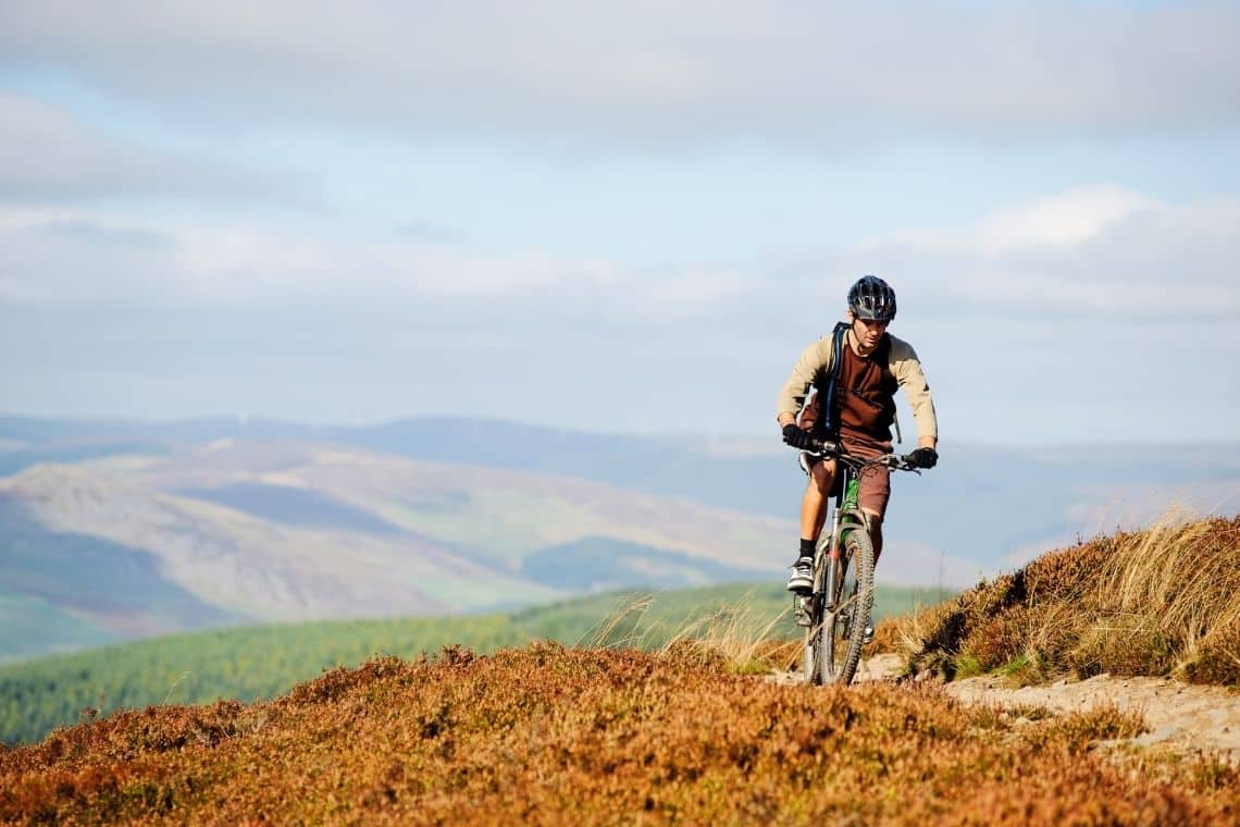 A man Mountain biking in scottish wilderness