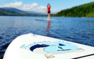photo of someone paddle boarding with SUP deck in foreground