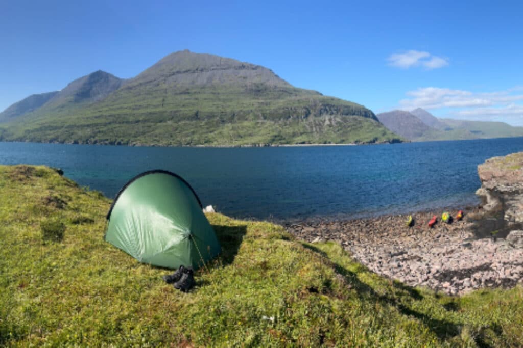 wild camping in skye, sea and mountains in the background
