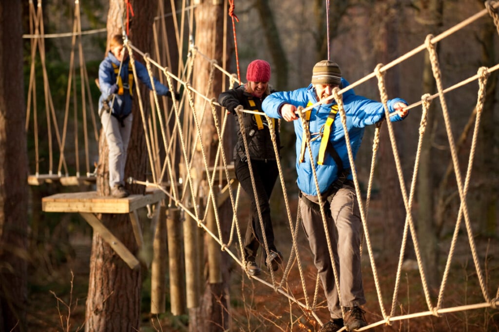 man on treezone rope bridge