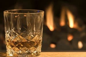 whisky glass by a fire
